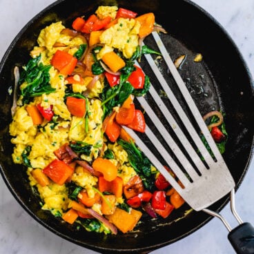 Healthy breakfast scramble with veggies in a skillet.